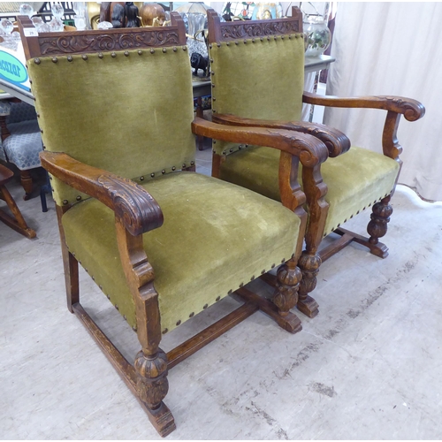 29 - A set of six 1920s carved oak framed dining chairs with green fabric stud upholstered, cushioned bac... 