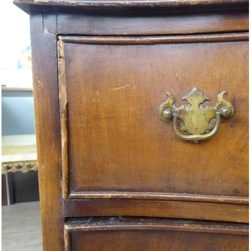 31 - Small furniture: to include an early 20thC walnut three drawer dressing chest, raised on bracket fee... 