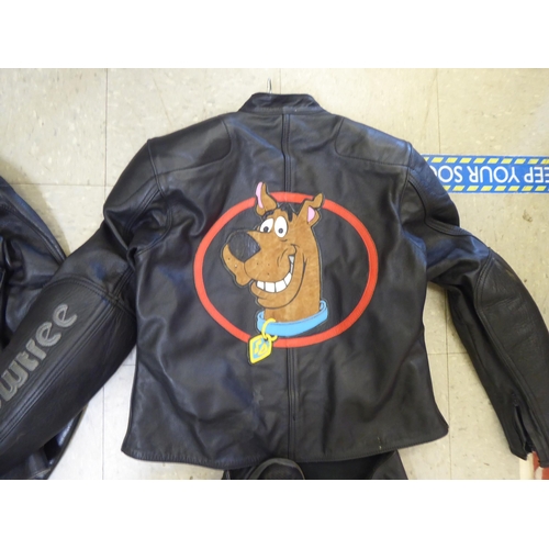 329 - Two sets of Crowtree black motorcycle leathers, one with Scoobydoo on the back of one jacket, the ot... 