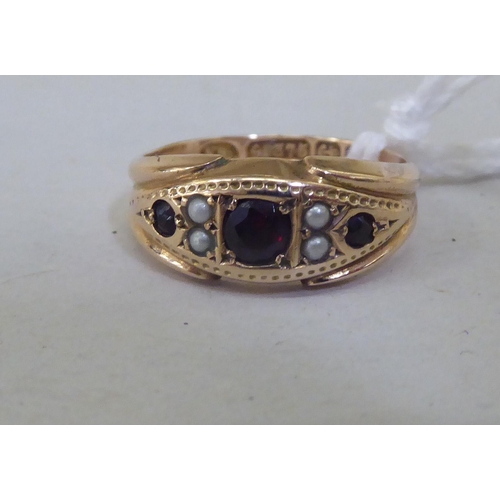 344 - A 9ct gold garnet and seed pearl ring 