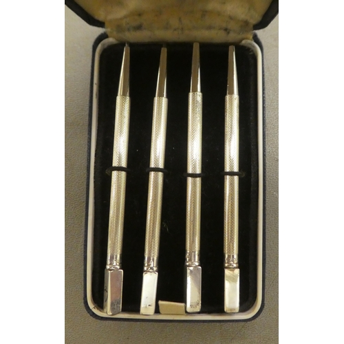 A set of four engine turned, Sterling silver bridge pencils cased