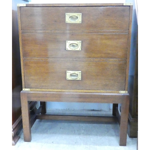 107 - A modern military design, brass bound mahogany cabinet with a facsimile three drawer front with a ri... 