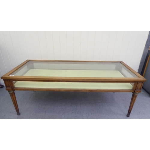 108 - A modern American cherrywood framed and glazed display coffee table, raised on tapered, fluted legs&... 