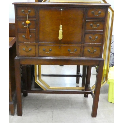 109 - A modern mahogany chest-on-stand with a facsimile fall front  42