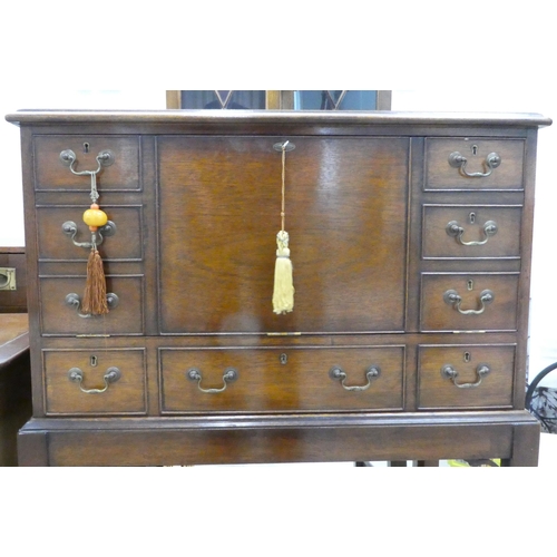 109 - A modern mahogany chest-on-stand with a facsimile fall front  42