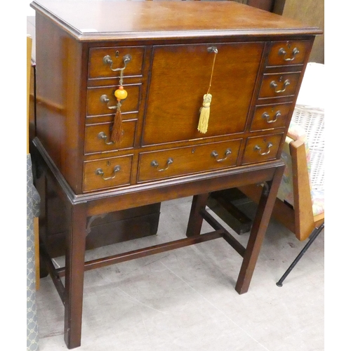 109 - A modern mahogany chest-on-stand with a facsimile fall front  42