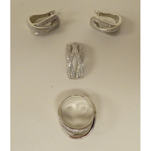 114 - Silver and cubic zirconia jewellery, viz. a ring, a pair of clip-on earrings and a scarf clip