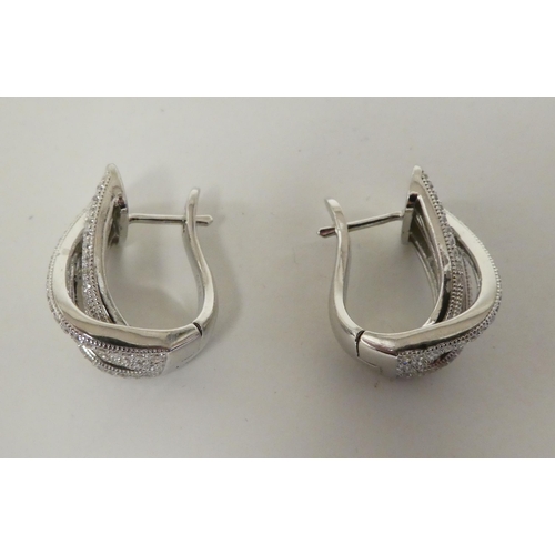 114 - Silver and cubic zirconia jewellery, viz. a ring, a pair of clip-on earrings and a scarf clip