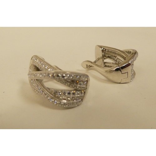 114 - Silver and cubic zirconia jewellery, viz. a ring, a pair of clip-on earrings and a scarf clip