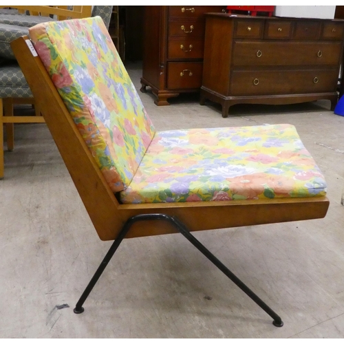 117 - A 1970s teak framed easy chair with webbing supports and splayed legs