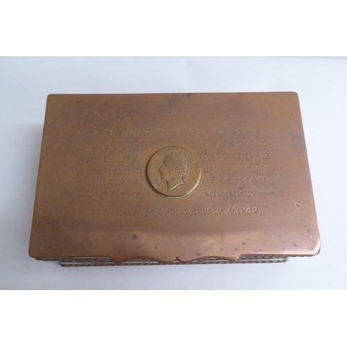 125 - A copper cigarette box with straight sides and a hinged lid, bearing a presentation inscription to L... 