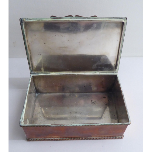 125 - A copper cigarette box with straight sides and a hinged lid, bearing a presentation inscription to L... 