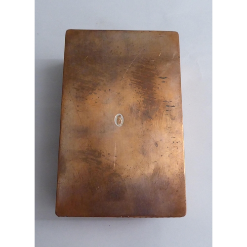 125 - A copper cigarette box with straight sides and a hinged lid, bearing a presentation inscription to L... 