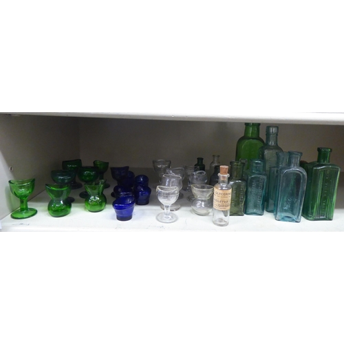 135 - Coloured glass chemist bottles and eye baths  largest 6