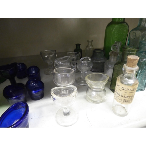 135 - Coloured glass chemist bottles and eye baths  largest 6