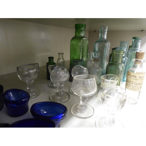 135 - Coloured glass chemist bottles and eye baths  largest 6