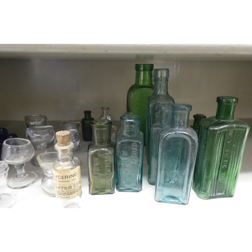 135 - Coloured glass chemist bottles and eye baths  largest 6