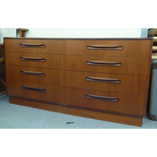 144 - A G-Plan teak dressing chest with two banks of four drawers, on a plinth  28