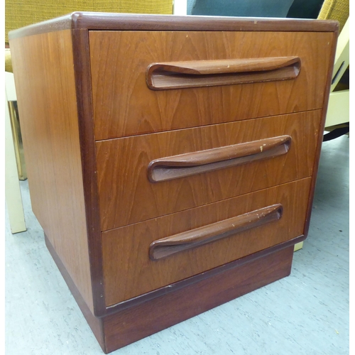 145 - A G-Plan teak bedside chest with three drawers, on a plinth  21