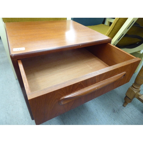 145 - A G-Plan teak bedside chest with three drawers, on a plinth  21