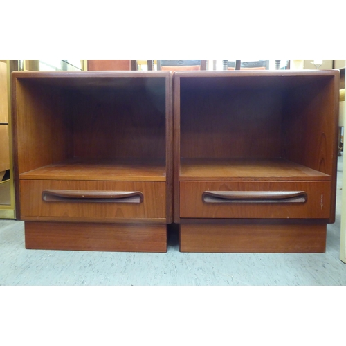 150 - A pair of G-Plan teak bedside cabinets, each with an open shelf and single drawer, on a plinth ... 