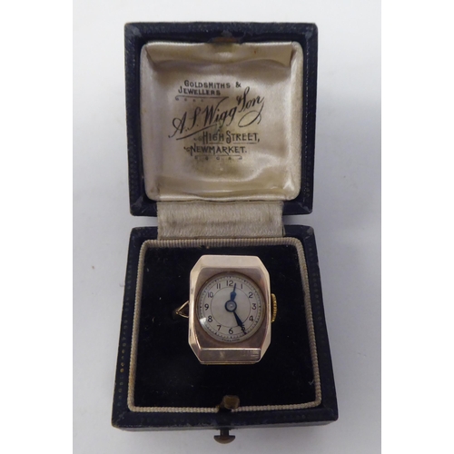 173 - A lady's gold coloured metal cased ring watch, faced by an Arabic dial