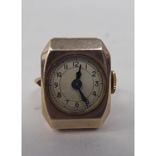 173 - A lady's gold coloured metal cased ring watch, faced by an Arabic dial