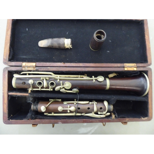 176 - A La Fleur & Son clarinet, in a compartmented wooden case; and a similar, J Michael Japanese exa... 