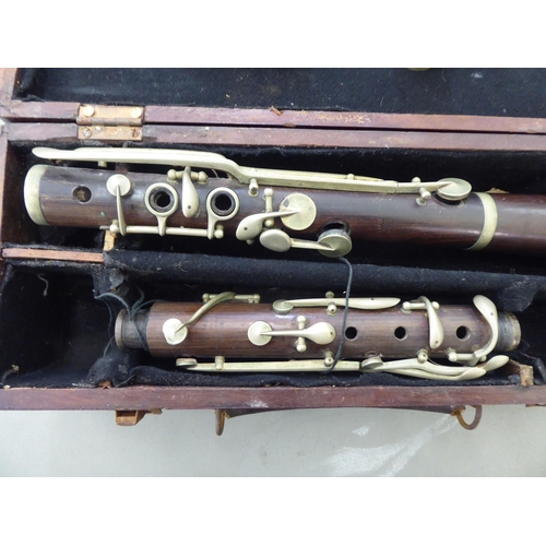 176 - A La Fleur & Son clarinet, in a compartmented wooden case; and a similar, J Michael Japanese exa... 