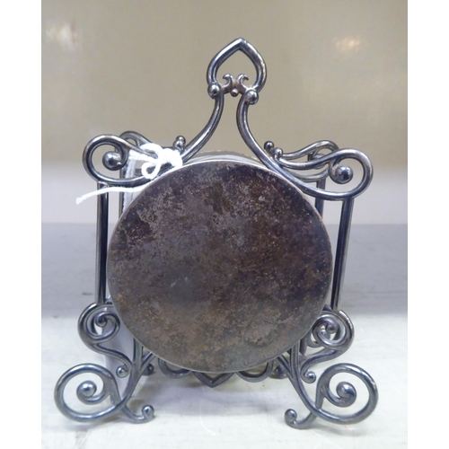 192 - A late Victorian silver cased mantel timepiece of drum design, in an ornately scrolled wire frame; t... 