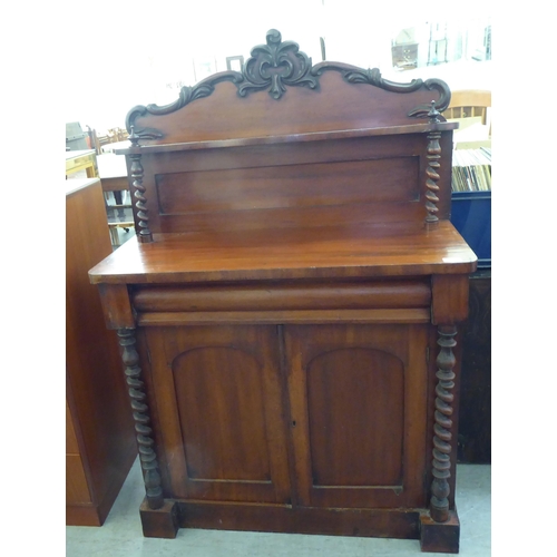 194 - A late Victorian mahogany chiffonier with a raised back, over a drawer and two panelled doors, on a ... 