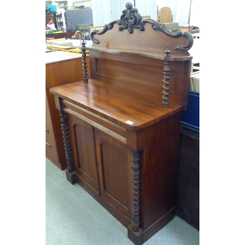 194 - A late Victorian mahogany chiffonier with a raised back, over a drawer and two panelled doors, on a ... 