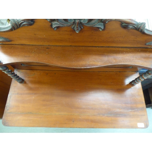 194 - A late Victorian mahogany chiffonier with a raised back, over a drawer and two panelled doors, on a ... 