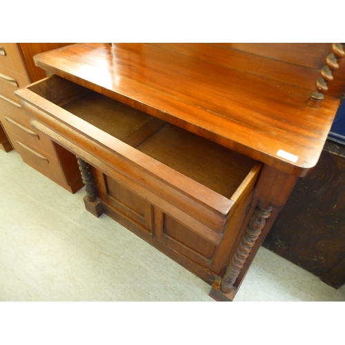 194 - A late Victorian mahogany chiffonier with a raised back, over a drawer and two panelled doors, on a ... 