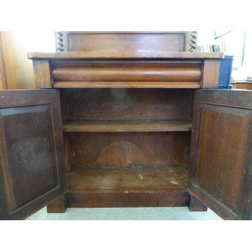 194 - A late Victorian mahogany chiffonier with a raised back, over a drawer and two panelled doors, on a ... 