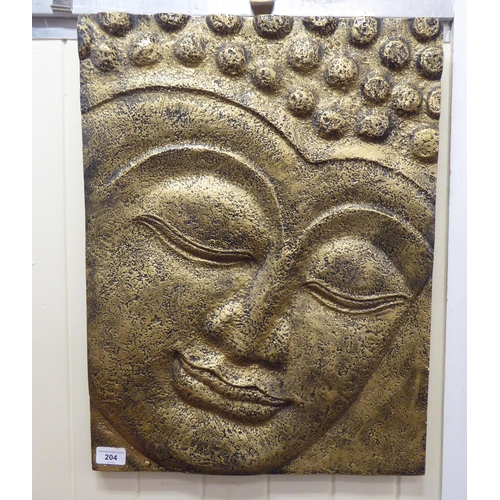 204 - A modern gilt sprayed and moulded composition plaque, the face of a Buddha  17.5