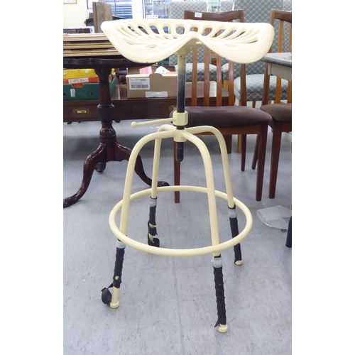 224 - A cream painted cast metal tractor seat design bar stool