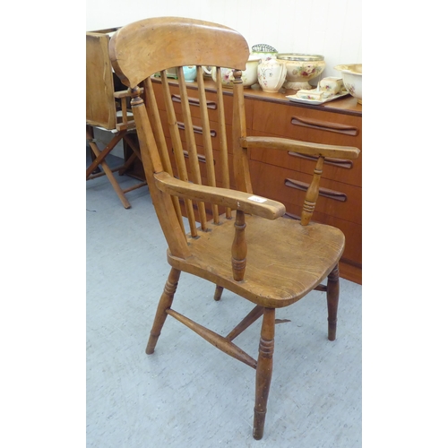 226 - A late Victorian beech and elm framed spindle back chair, raised on turned legs