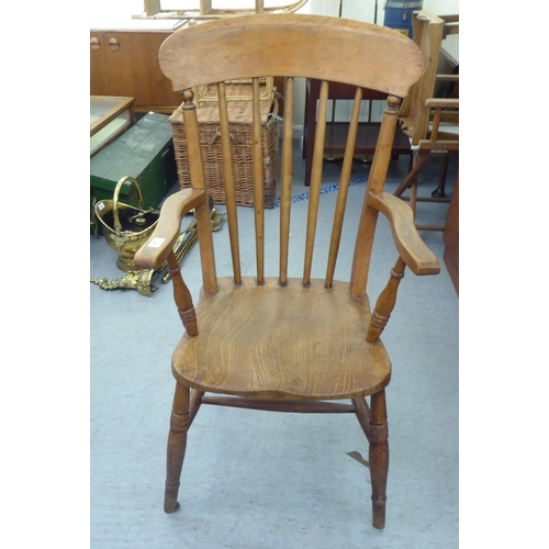 226 - A late Victorian beech and elm framed spindle back chair, raised on turned legs