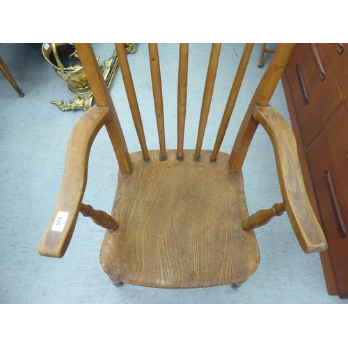 226 - A late Victorian beech and elm framed spindle back chair, raised on turned legs