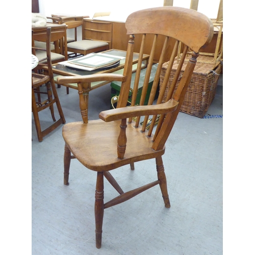 226 - A late Victorian beech and elm framed spindle back chair, raised on turned legs