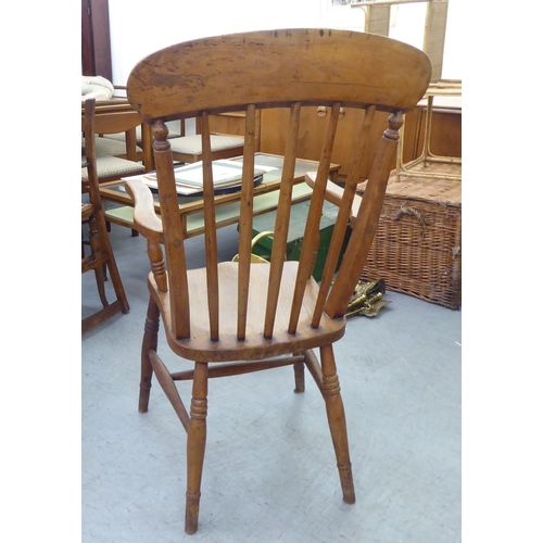 226 - A late Victorian beech and elm framed spindle back chair, raised on turned legs