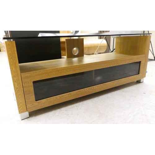 23 - A modern laminated light oak effect and tinted glass television stand  19