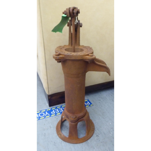 237 - A rust coloured cast iron replica of a 19thC water pump head  21