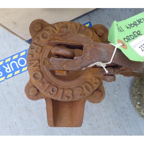 237 - A rust coloured cast iron replica of a 19thC water pump head  21