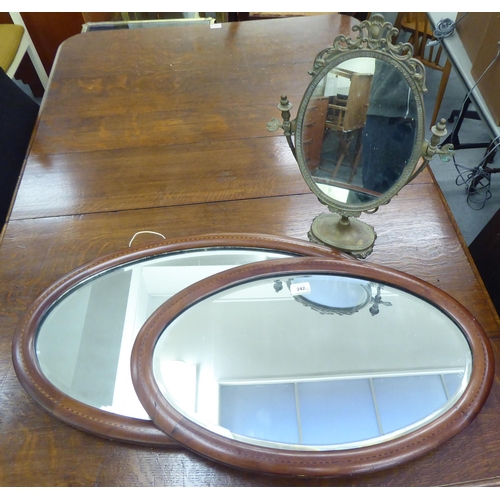 242 - Three mirrors: to include an Edwardian example, in a satinwood inlaid mahogany frame  16