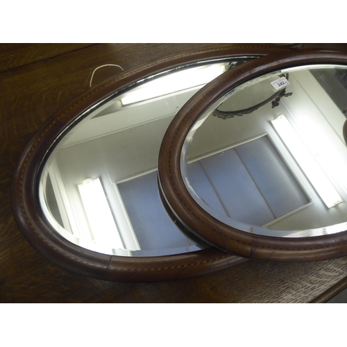 242 - Three mirrors: to include an Edwardian example, in a satinwood inlaid mahogany frame  16