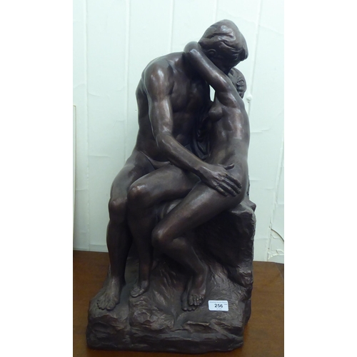 256 - After Rodin - a bronze coloured pottery model, an embracing couple  24