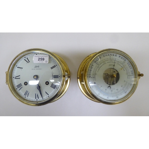 259 - A lacquered brass cased bulkhead 8 day timepiece; and similar barometer  each 7