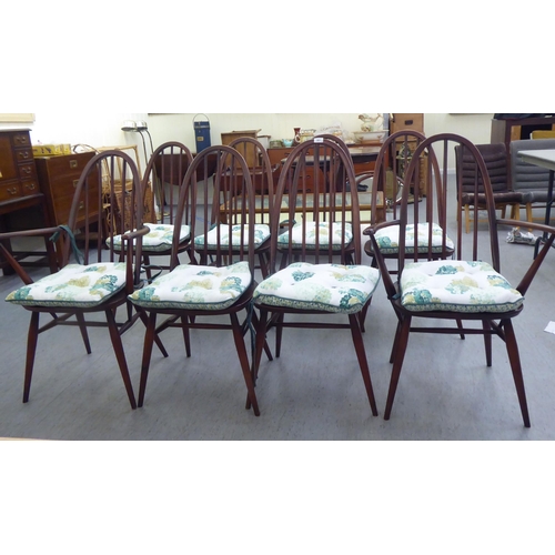 261 - A set of eight Ercol beech and elm framed spindled high hoop back dining chairs, raised on turned le... 